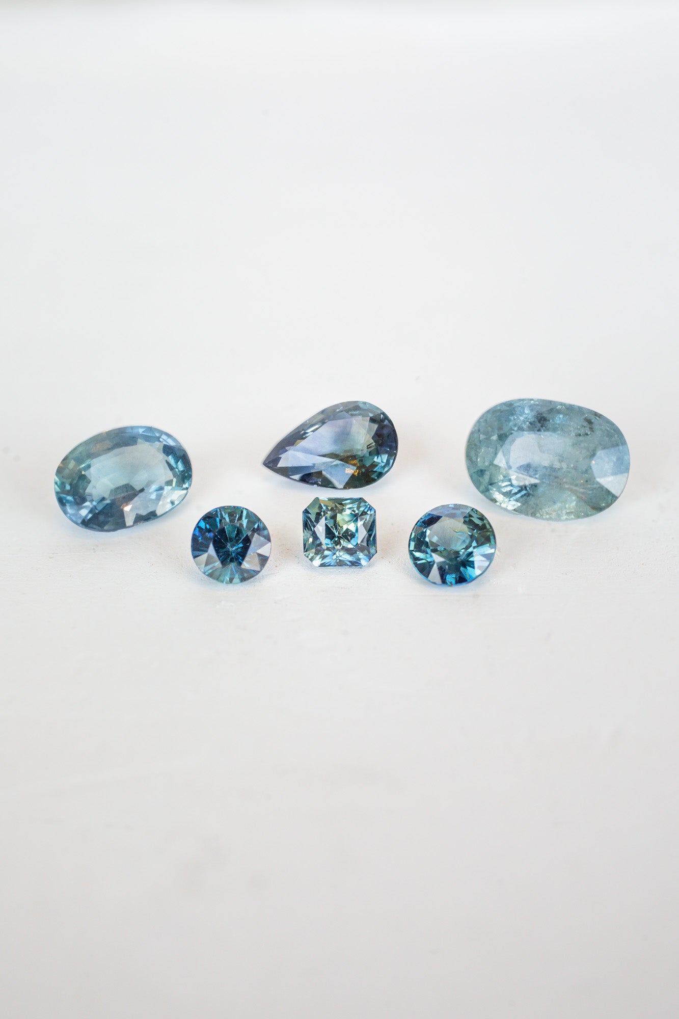 A collection of blue sapphire stones, birthstones for September, shining brightly in a mesmerizing display.
