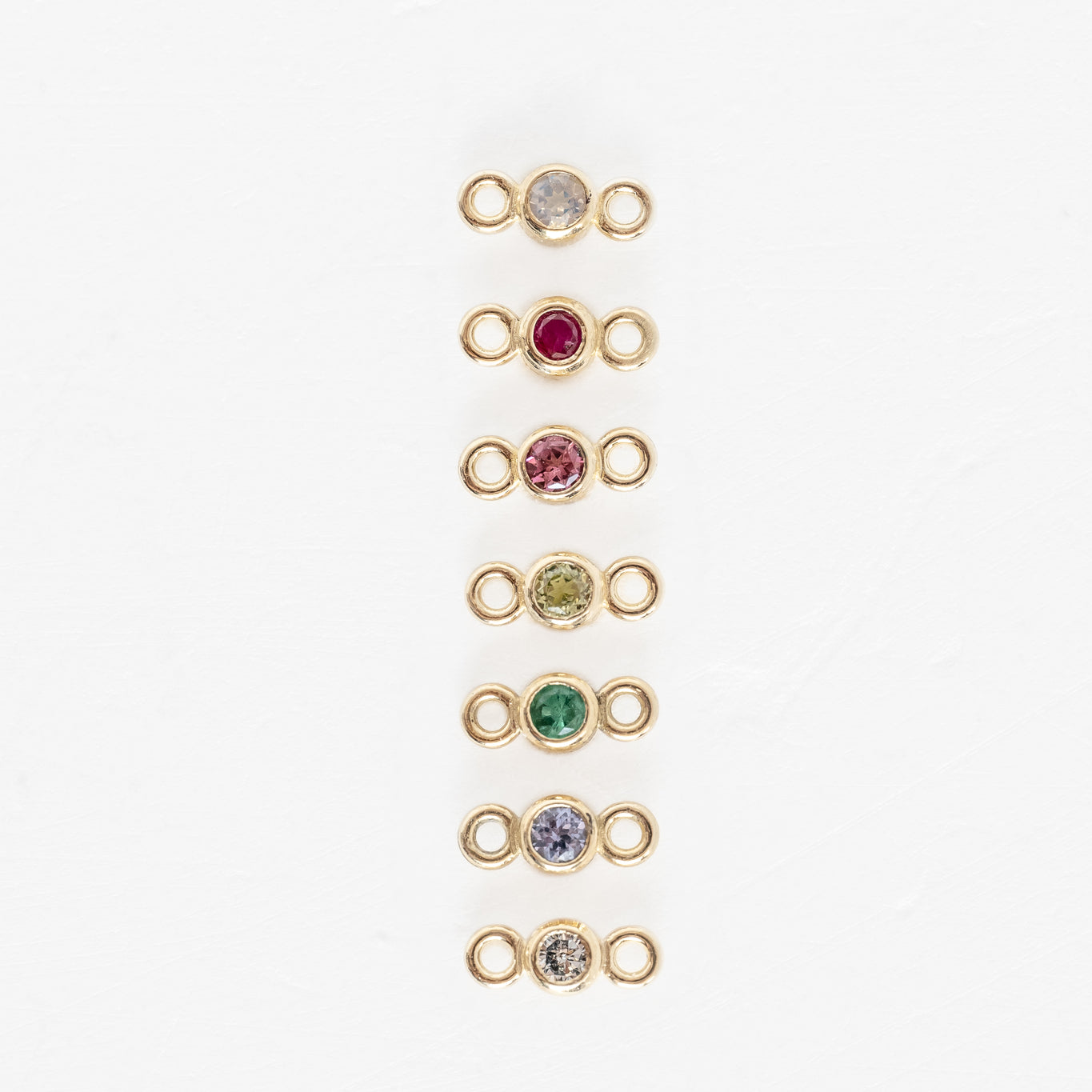 Four gold plated links with multi colored stones, featuring Forever Linked Bezels Birthstones 2mm Charms.