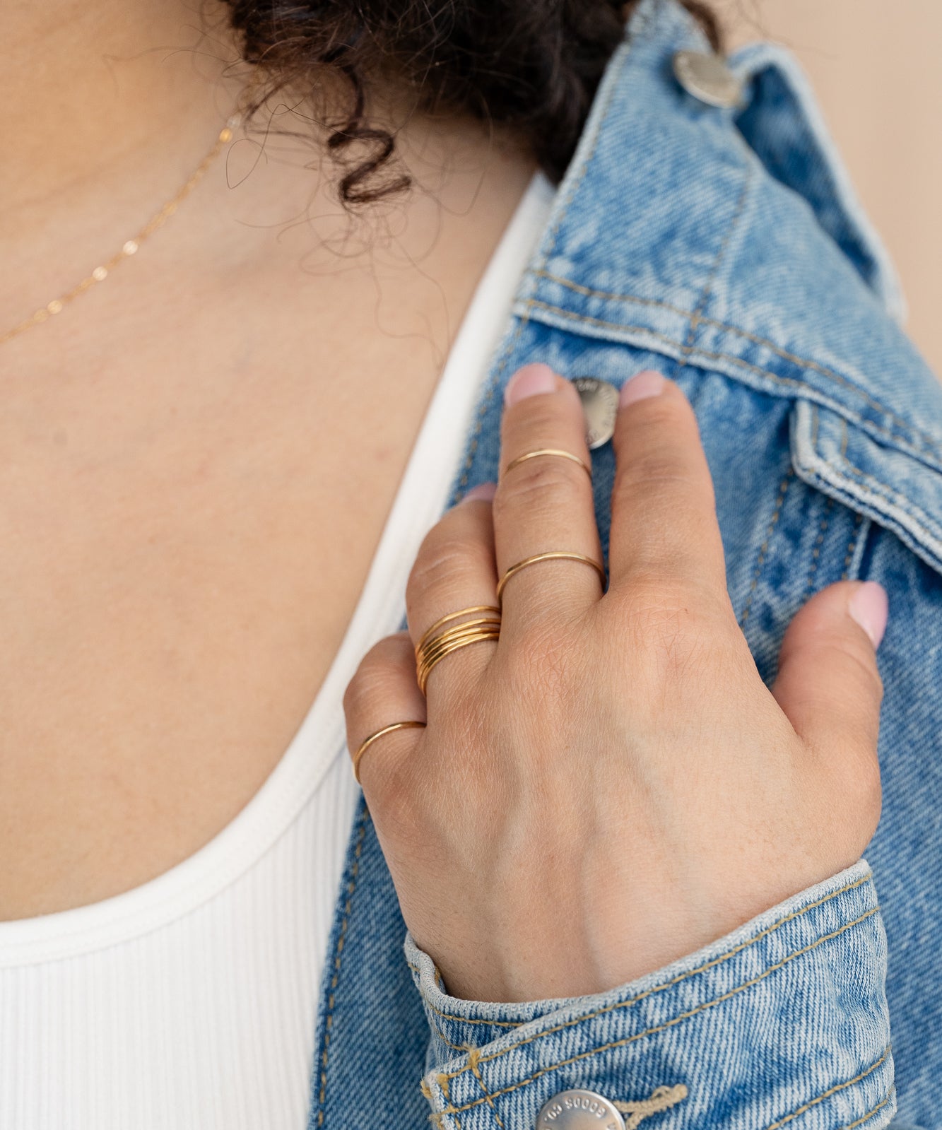 Gold concentric midi ring on neutral background