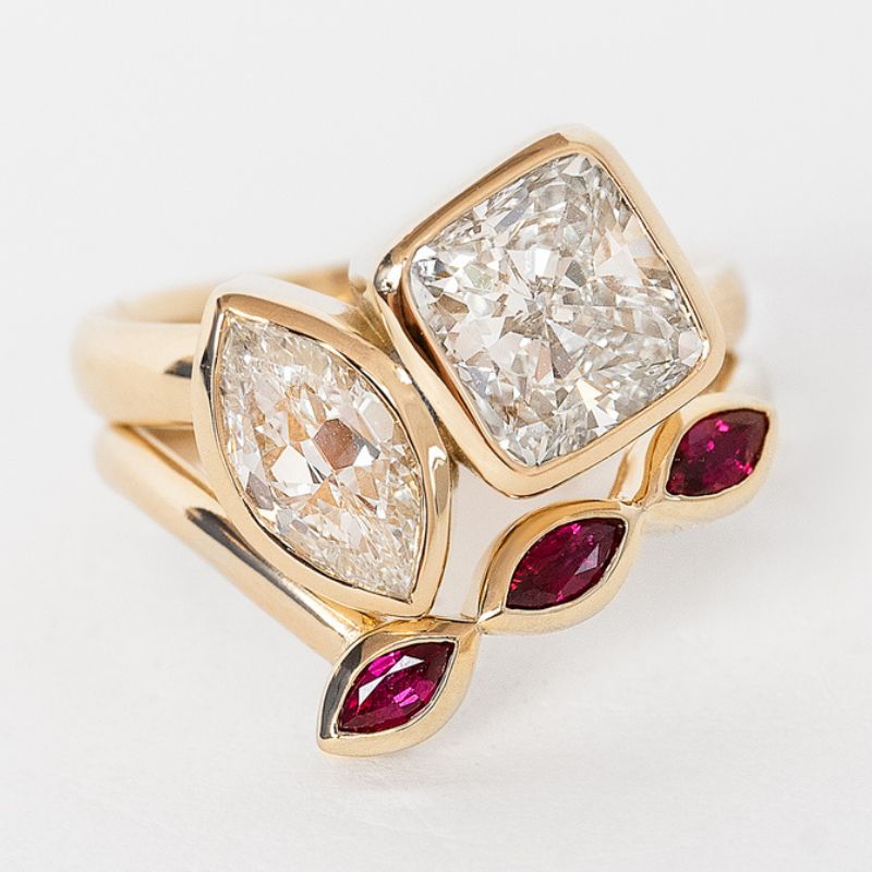 Custom jewelry ring with two diamonds and three ruby stones.