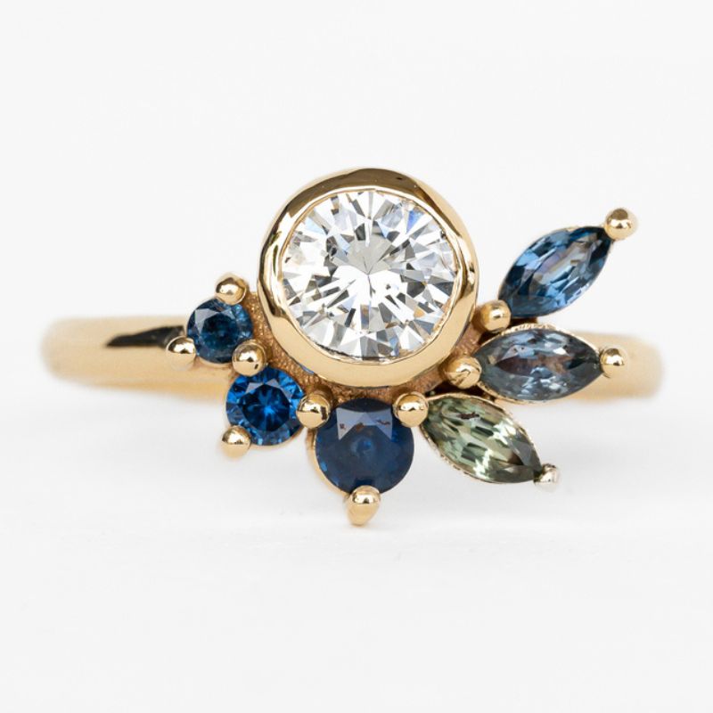 A beautiful handmade custom jewelry ring adorned with blue sapphires and white diamonds,
