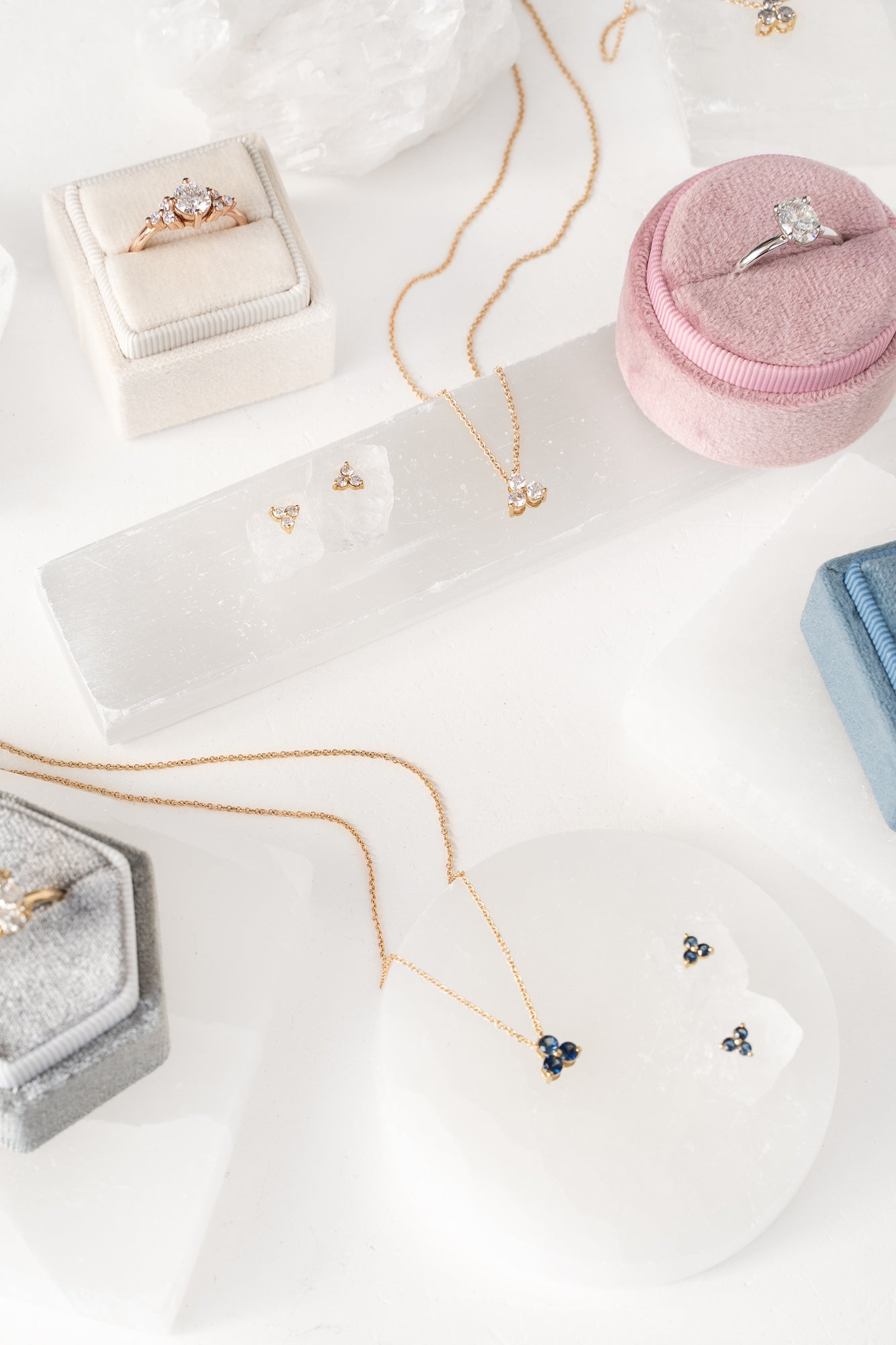 Jewelry and rings on a white surface. A collection of elegant accessories showcasing various designs and precious gemstones.