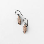 Close-up of textured oxidized earrings