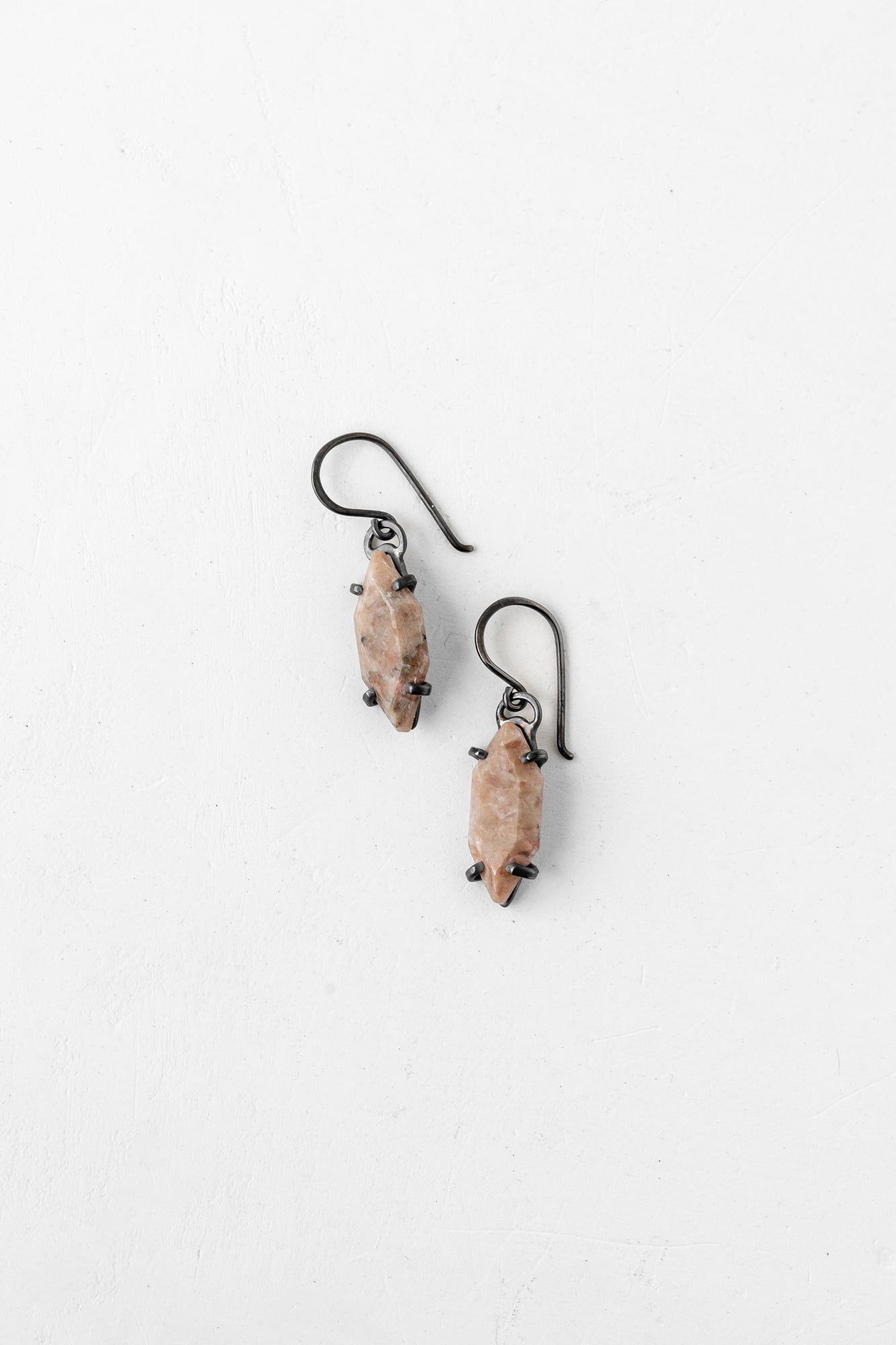 Close-up of textured oxidized earrings