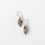 Speckled silver earrings with intricate design