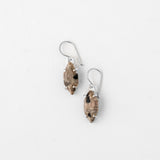 Speckled silver earrings with intricate design