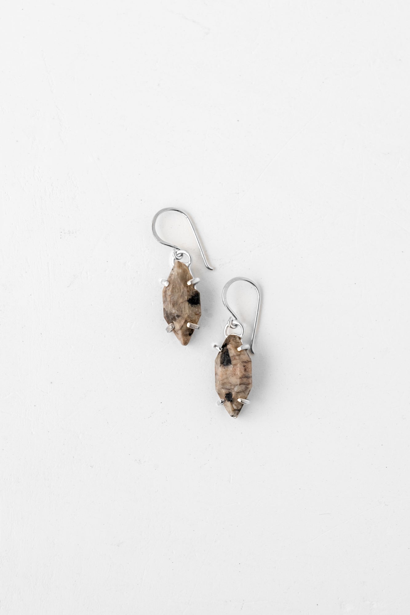 Speckled silver earrings with intricate design