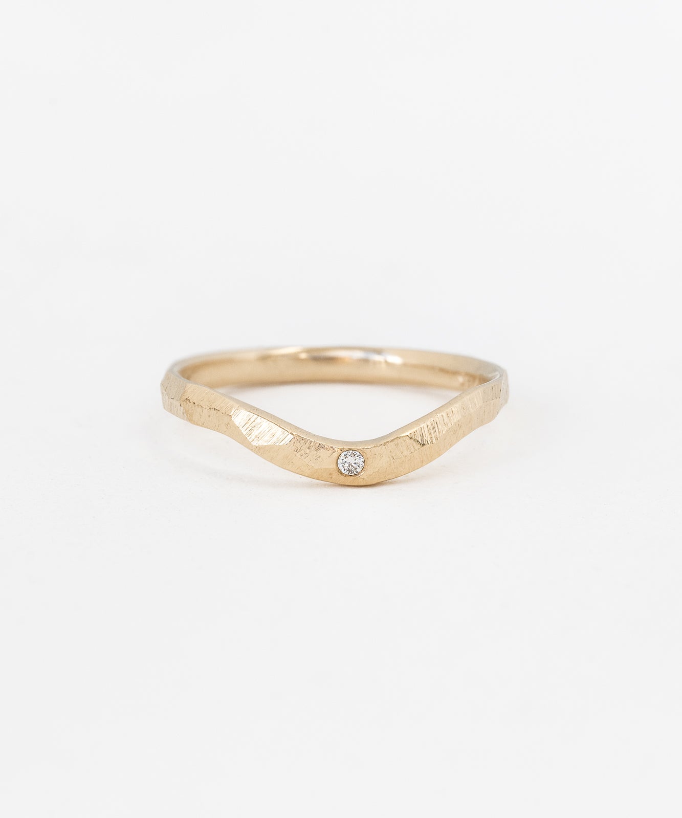 Multifaceted contour ring with central stone
