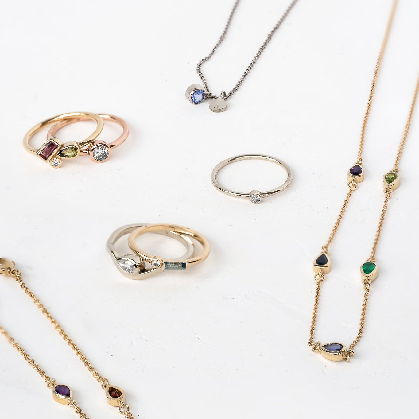 A variety of customizable jewelry pieces including rings, necklaces, and bracelets.