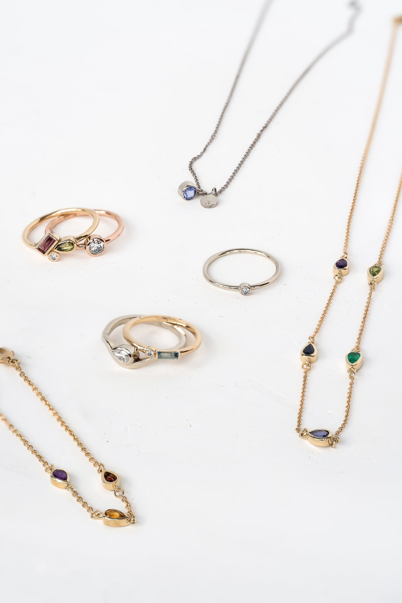 A variety of customizable jewelry pieces including rings, necklaces, and bracelets.