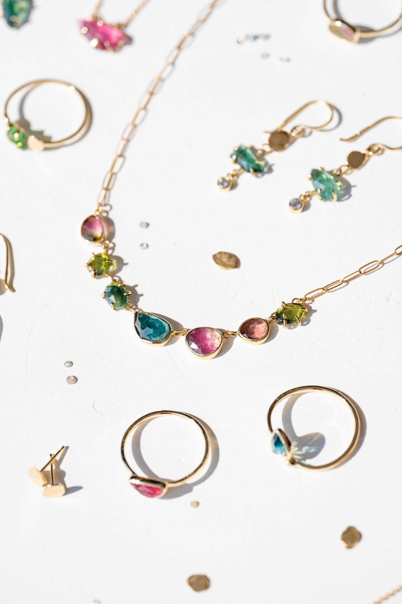 Colorful stone with gold jewelry from The El Dorado Collection, featuring vibrant gemstones in various designs.