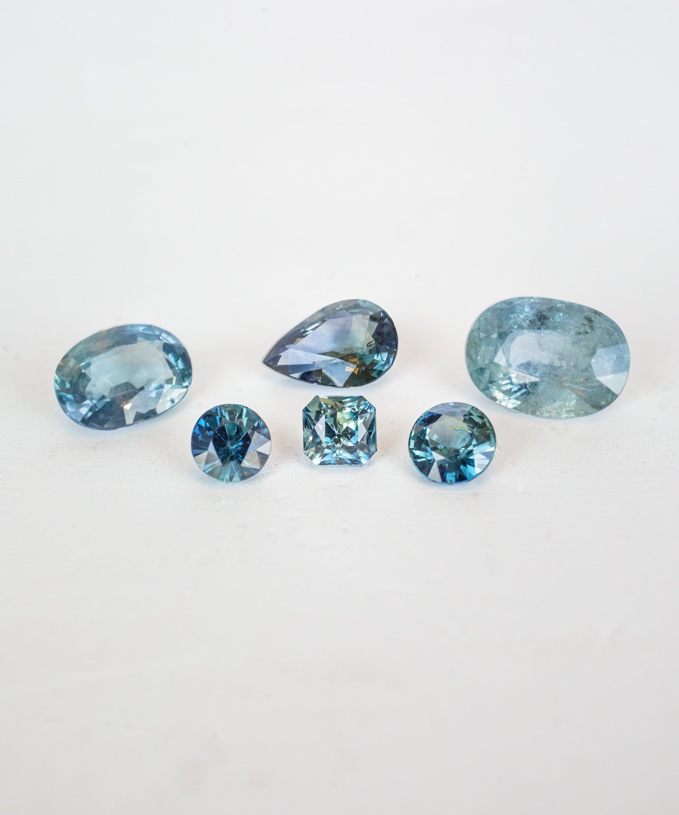 A collection of blue sapphire stones, birthstones for September, shining brightly in a mesmerizing display.