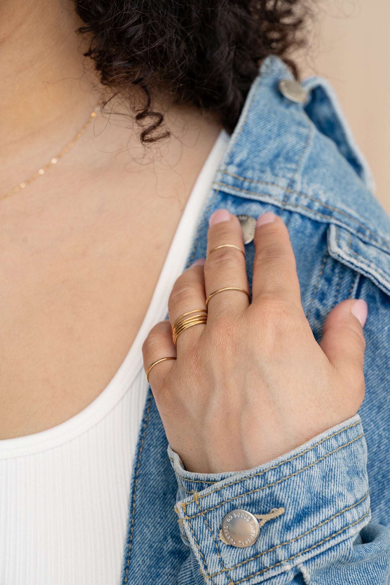 Gold concentric midi ring on neutral background