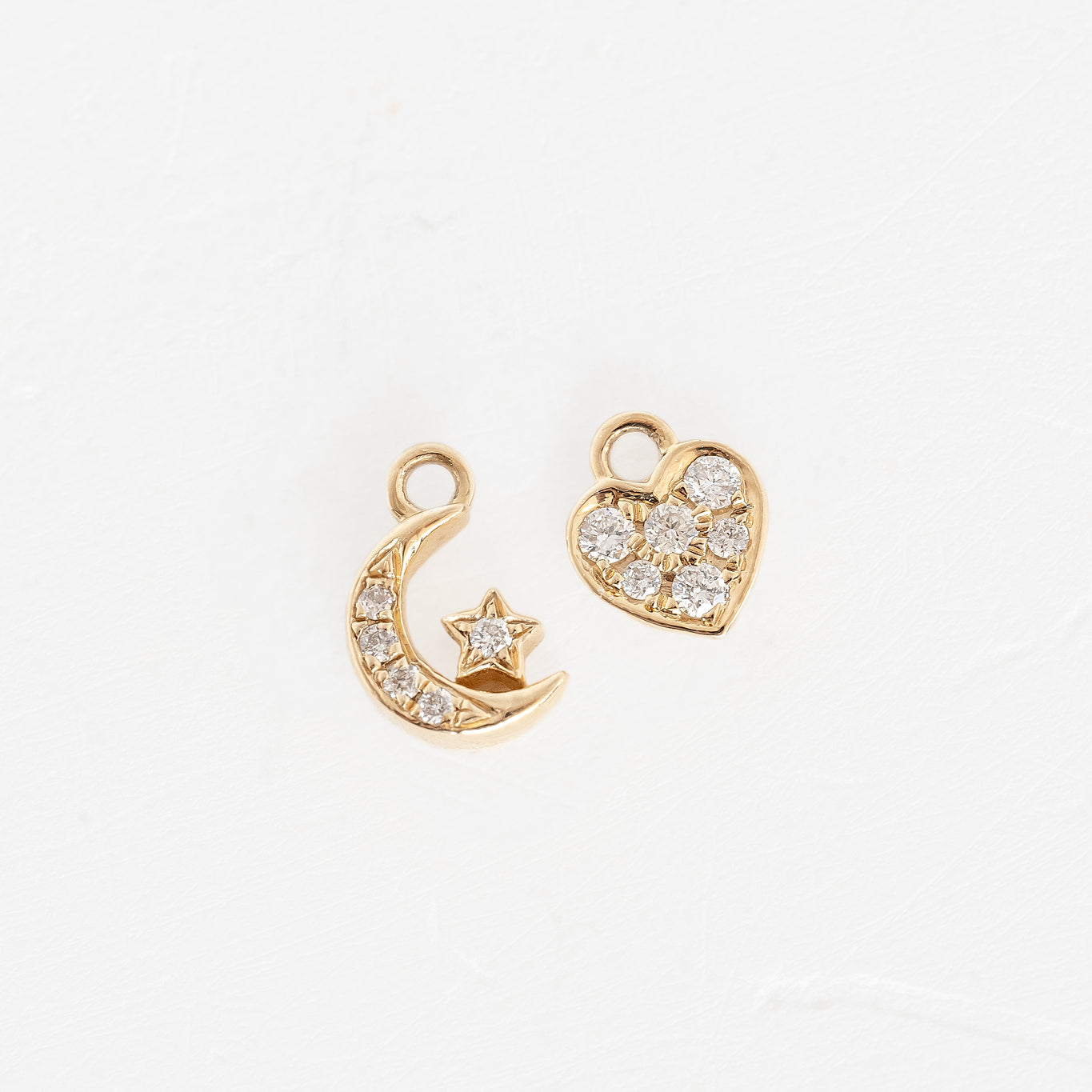 Two gold heart and moon charms with diamonds, forever linked in a beautiful design.