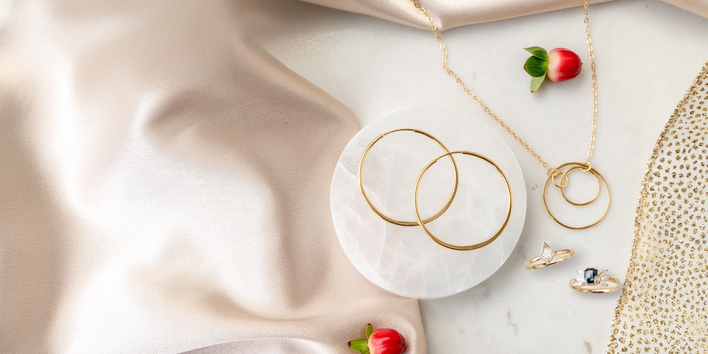 Concentric collection and engagement rings displayed on a holiday themed flat  scene.  Elaine B Jewelry.