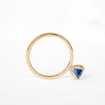A ring featuring a stunning blue sapphire stone, perfect for adding a touch of elegance to any outfit.