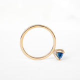 A ring featuring a stunning blue sapphire stone, perfect for adding a touch of elegance to any outfit.