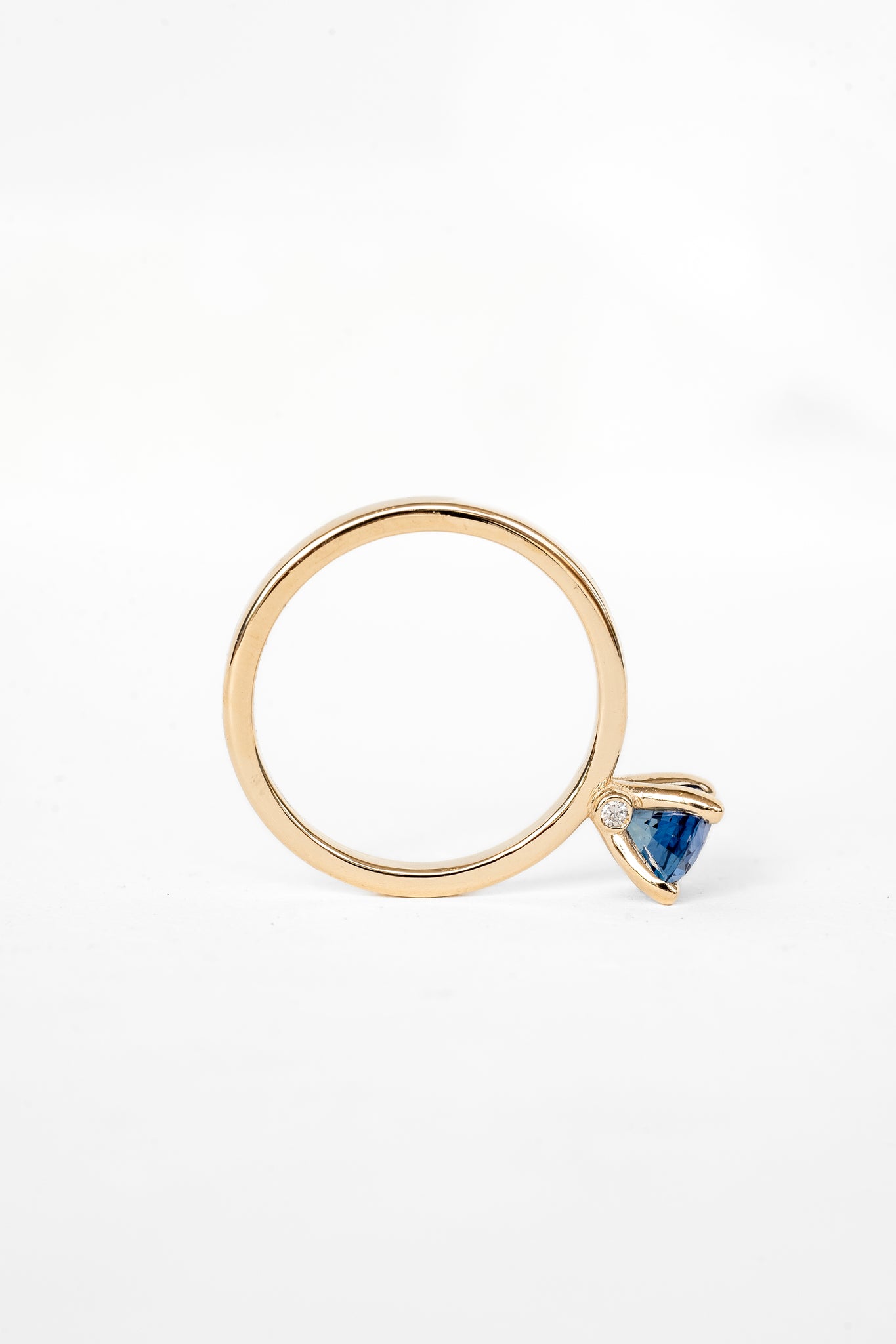 A ring featuring a stunning blue sapphire stone, perfect for adding a touch of elegance to any outfit.