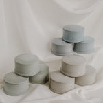 Pastel cement jewelry dishes on white background