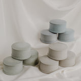 Pastel cement jewelry dishes on white background