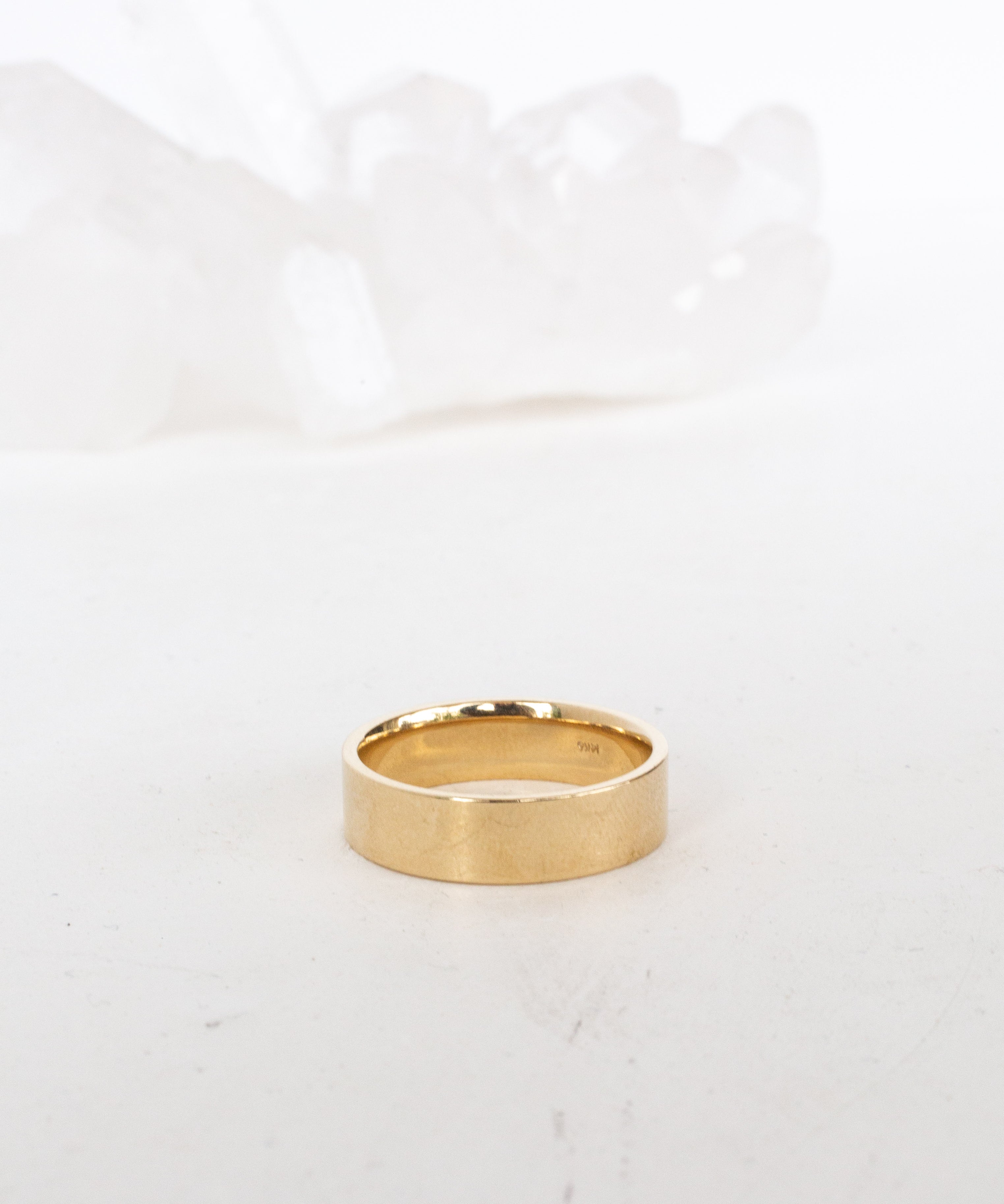 Close-up of minimalist gold necklace pendant