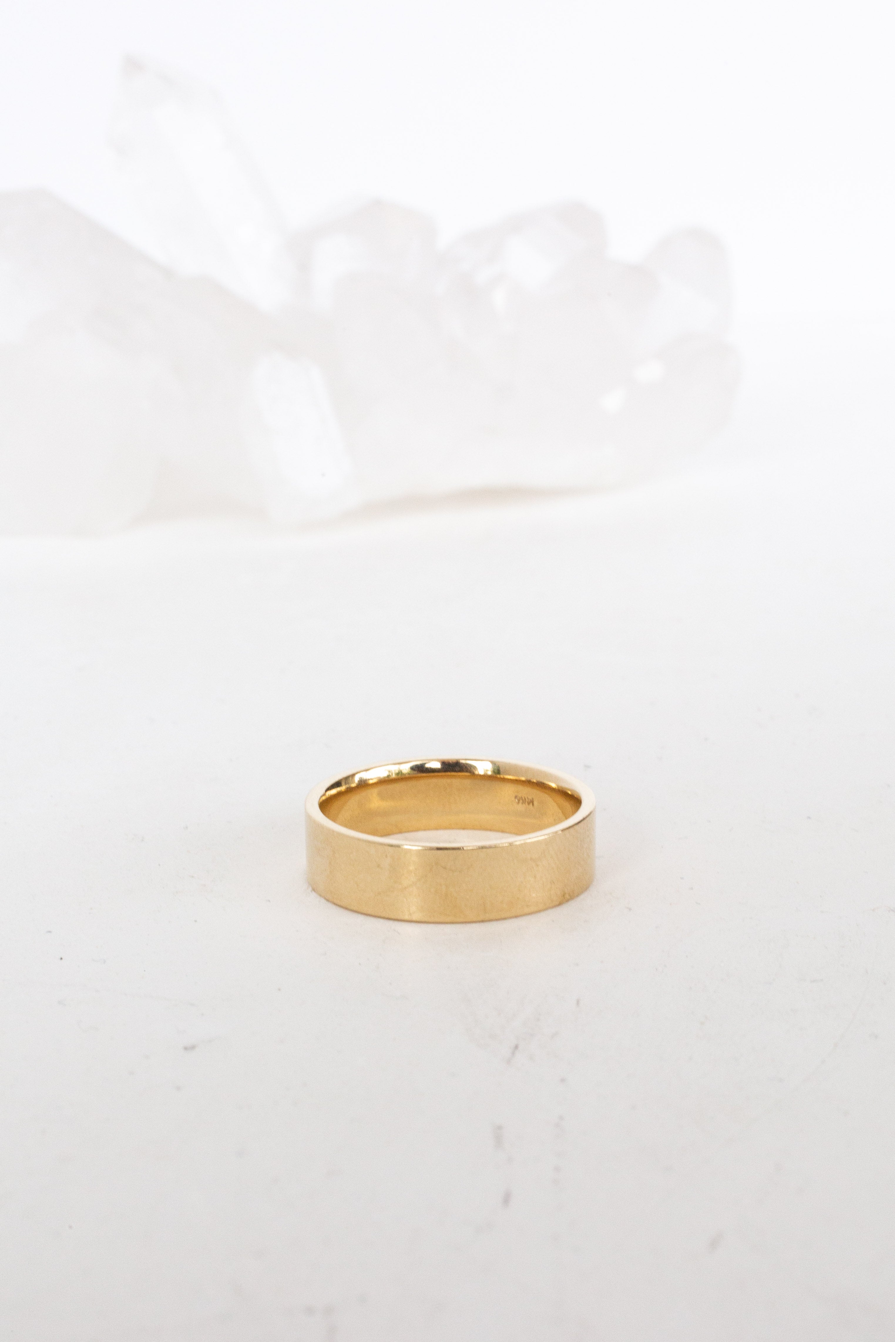 Close-up of minimalist gold necklace pendant