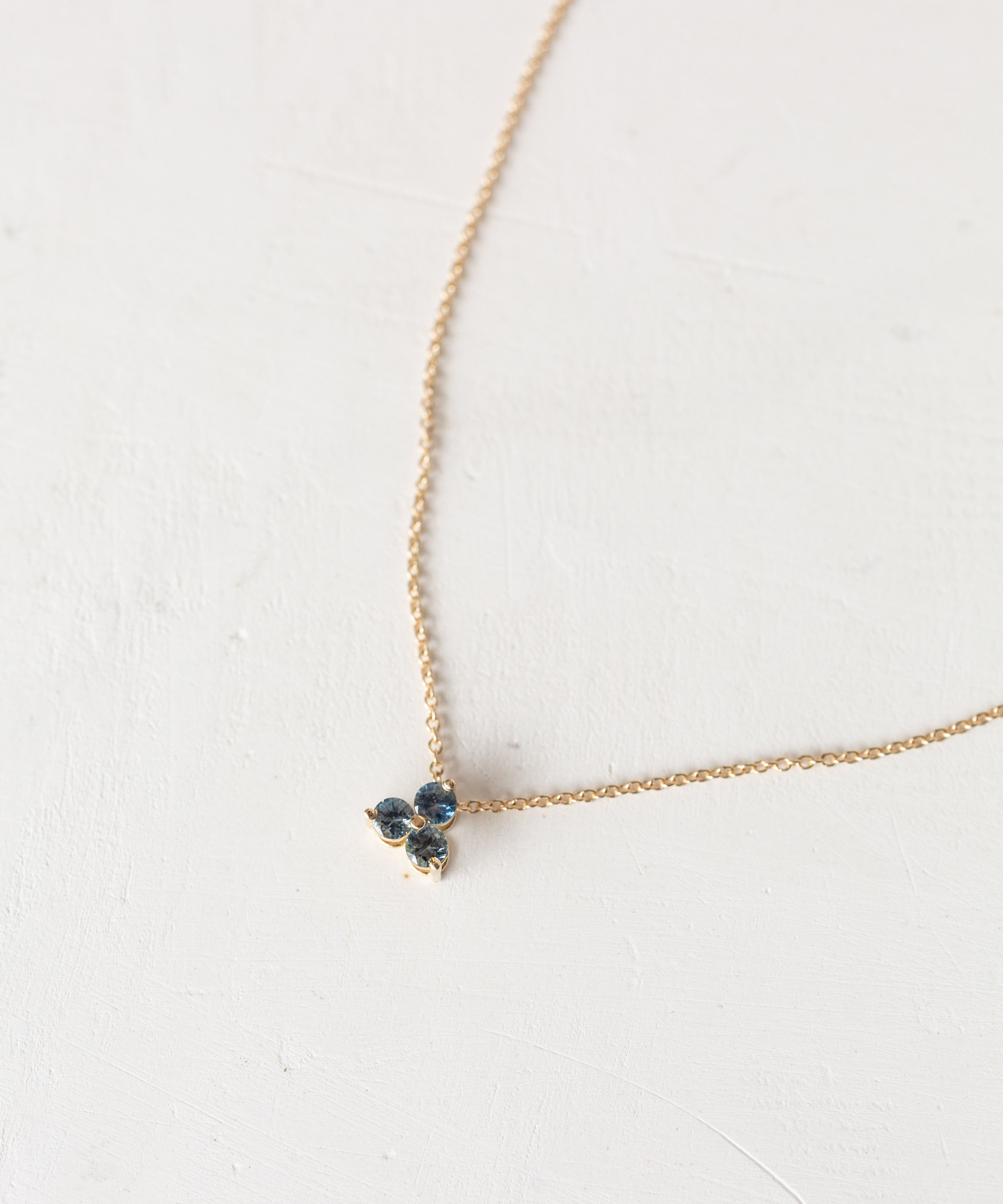 Gold Trinity and Moon necklace close-up